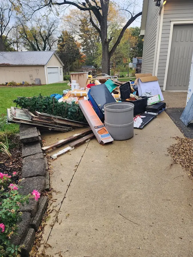 Dumpster being loaded with debris for 12 Yard Dumpster Rental in Reedley